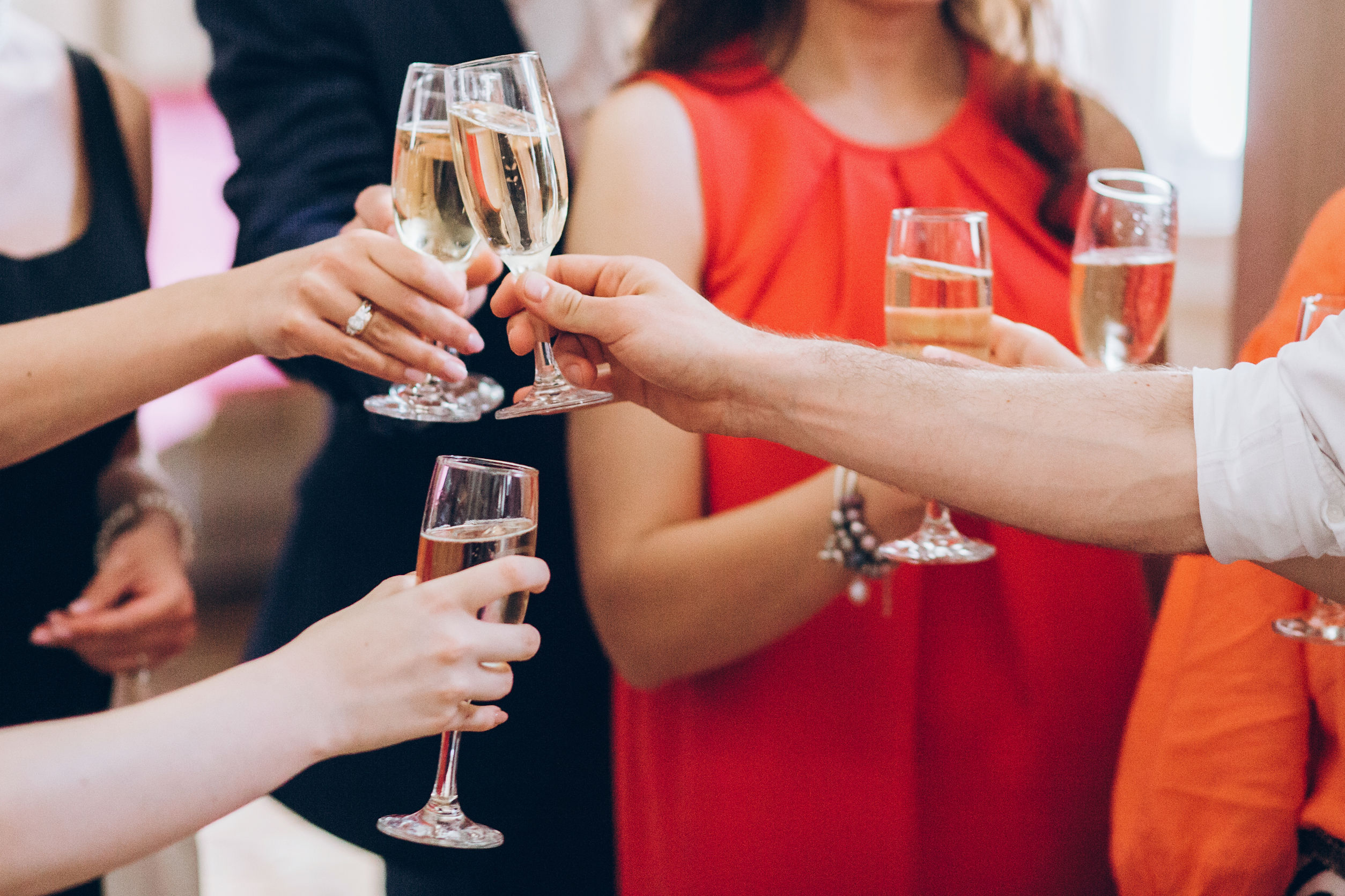 group of elegant people holding glasses of champagne at luxury w Christmas Party