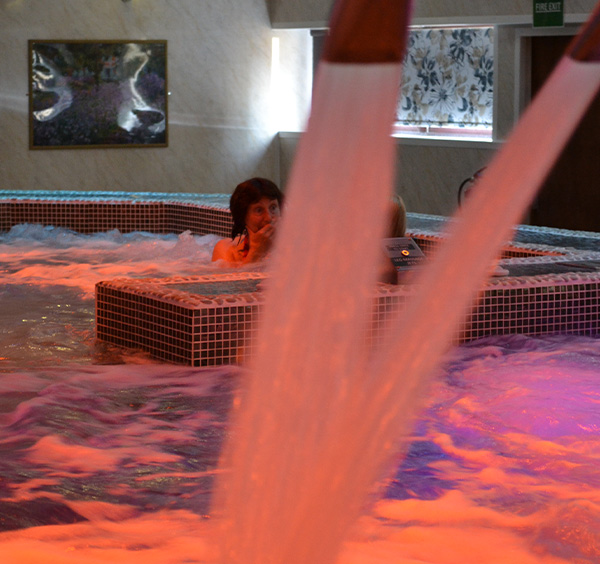 HydroPool couple relaxing in manor resort hydro pool and spa