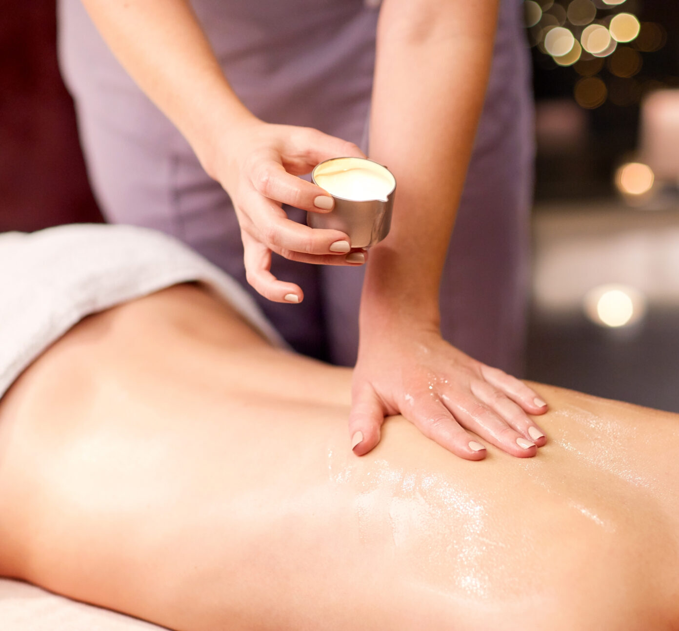 woman lying and having back massage at spa